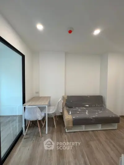 Modern living room with sleek furniture and wooden flooring in a contemporary apartment.