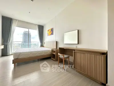 Spacious bedroom with modern furnishings and city view, featuring large windows and elegant decor.