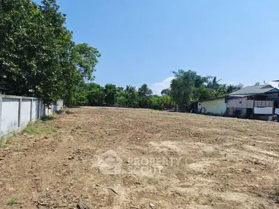 Spacious vacant land with lush greenery, perfect for development opportunities.