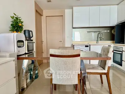 Modern kitchen with sleek appliances and dining area in a stylish apartment.