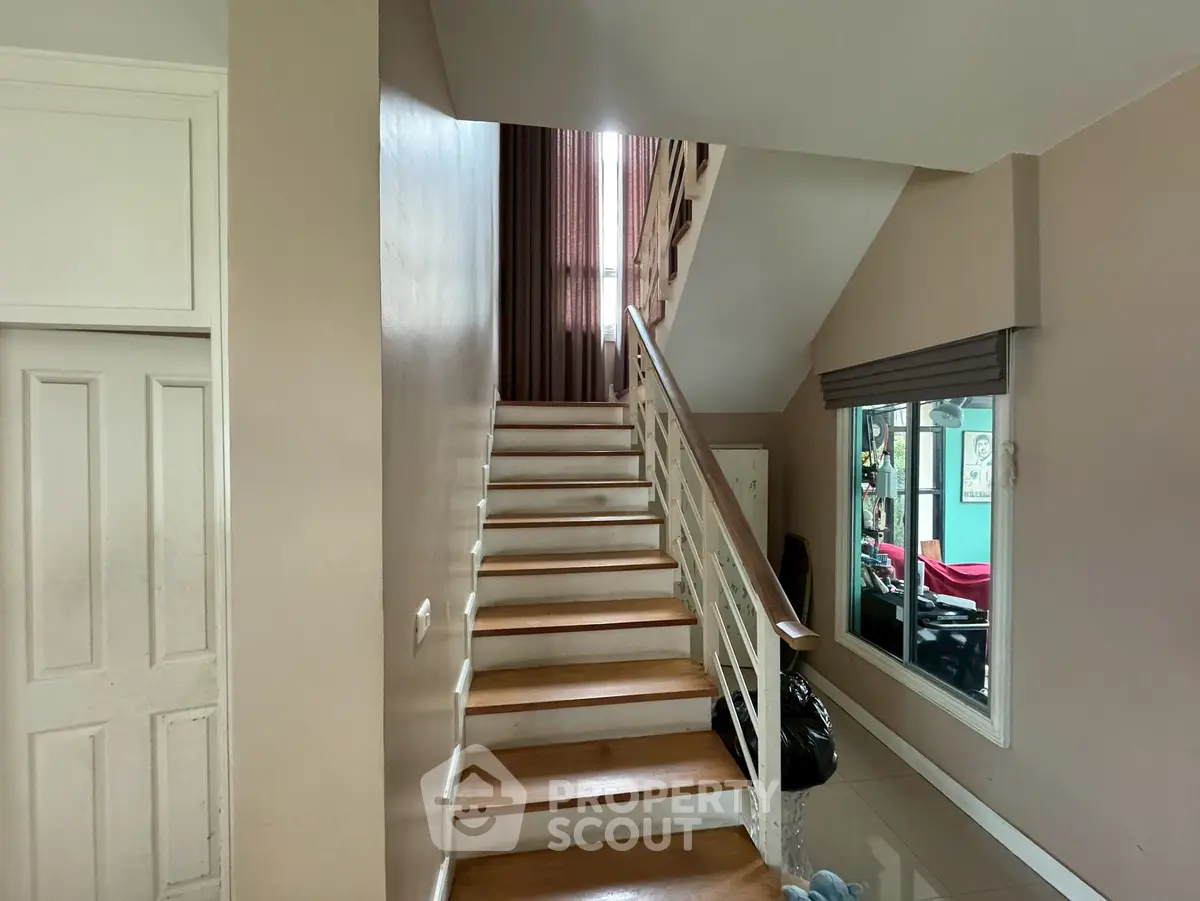 Stylish staircase in modern home with sleek design and natural lighting