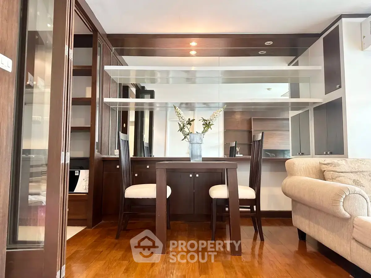 Elegant dining area with wooden furniture and modern decor in a cozy apartment setting.