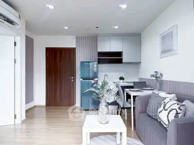 Modern living room with sleek kitchen and stylish decor in open layout apartment.