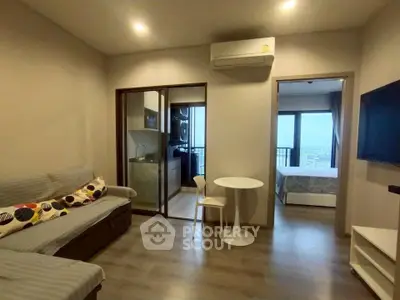 Modern apartment living room with open kitchen and balcony view