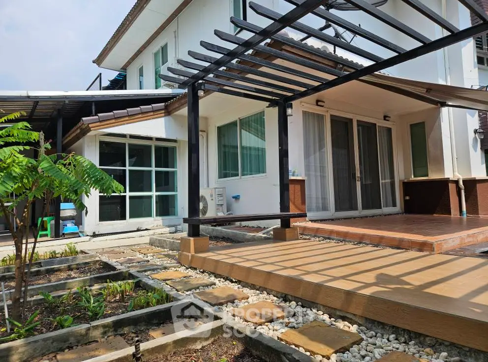Charming modern house with spacious patio and garden, perfect for outdoor living and entertaining.