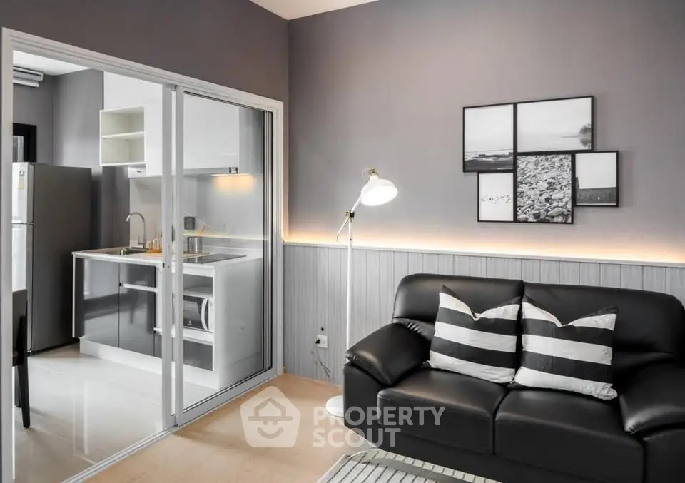 Modern living room with sleek kitchen and stylish decor