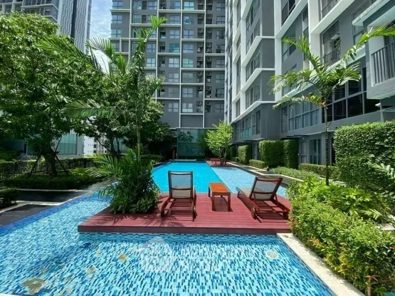 Luxurious condominium with stunning poolside view and lush greenery