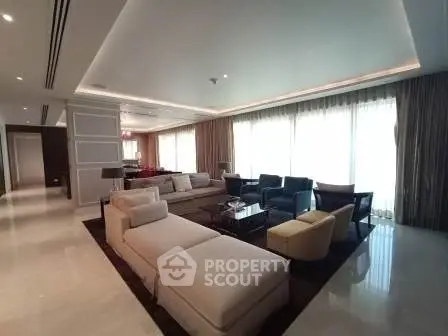 Luxurious and spacious living room with elegant furniture and large windows.