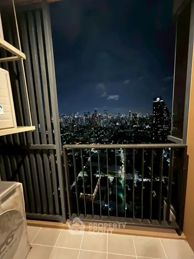 Stunning high-rise balcony view of city skyline at night, perfect for urban living.