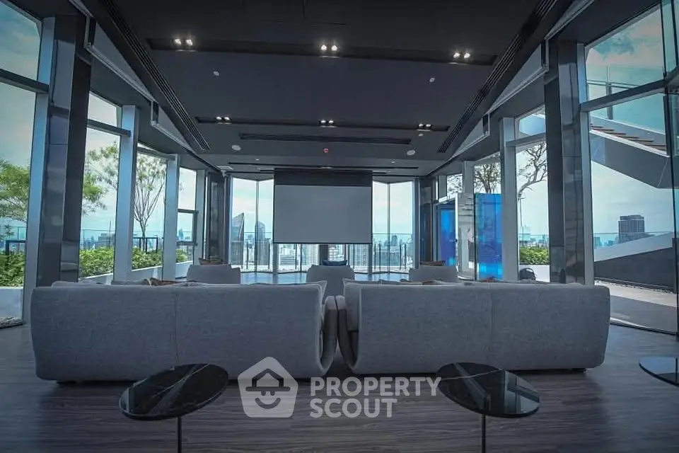 Luxurious modern living room with panoramic city views and sleek furnishings.