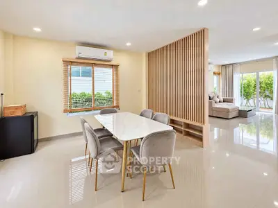 Spacious modern living room with elegant dining area and natural light