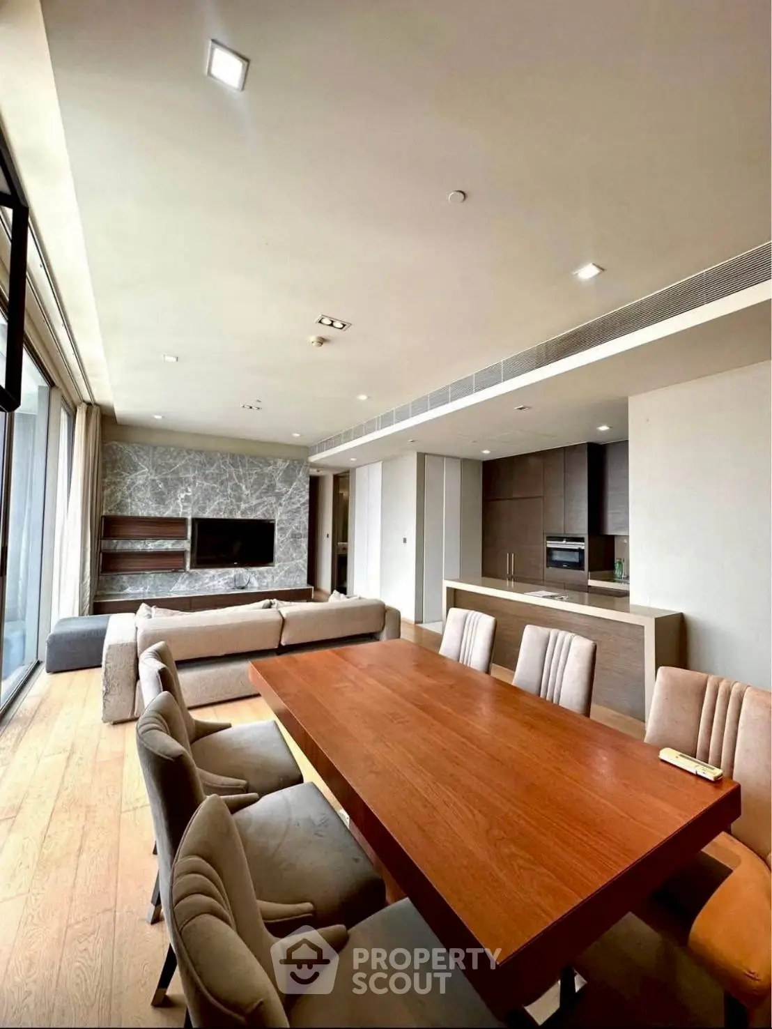 Spacious modern living room with open kitchen and elegant dining area