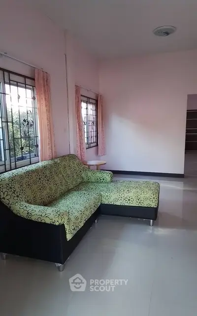 Spacious living room with stylish sofa and large windows for natural light