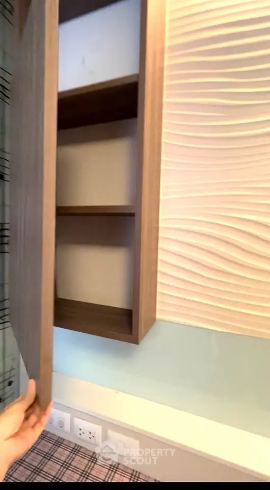 Modern wall-mounted wooden cabinet with open shelves in stylish interior design.