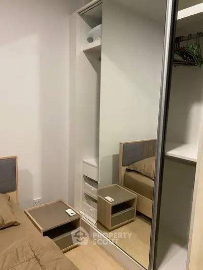 Modern bedroom with mirrored wardrobe and cozy bed setup