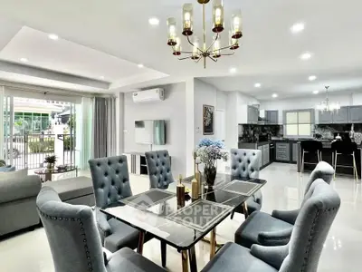 Luxurious open-plan living and dining area with elegant decor and modern kitchen.