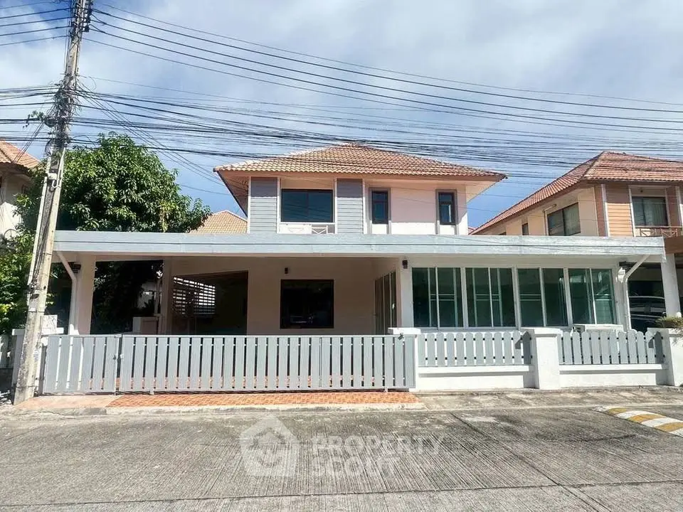 Charming two-story house with spacious front yard and modern design in a serene neighborhood.