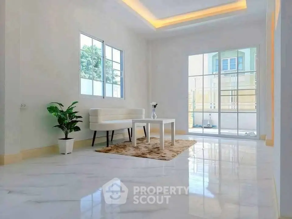 Spacious modern living room with large windows and elegant decor