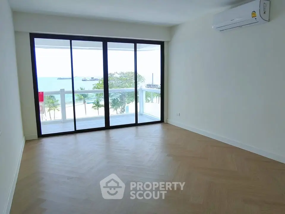 Spacious living room with stunning ocean view and large balcony access.