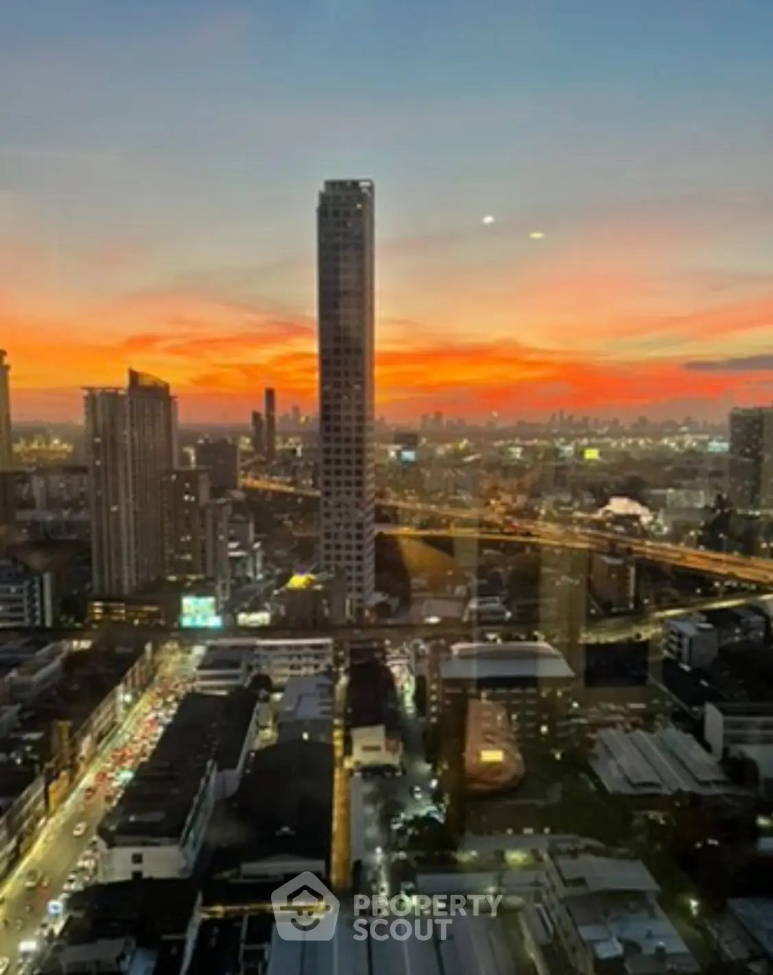Stunning cityscape view from high-rise building at sunset, showcasing vibrant skyline and urban landscape.