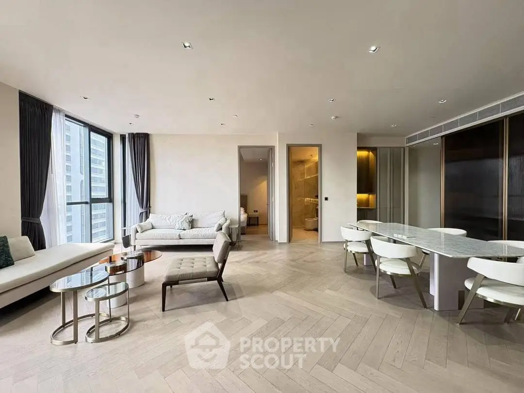 Luxurious modern living room with elegant dining area and large windows offering city views.