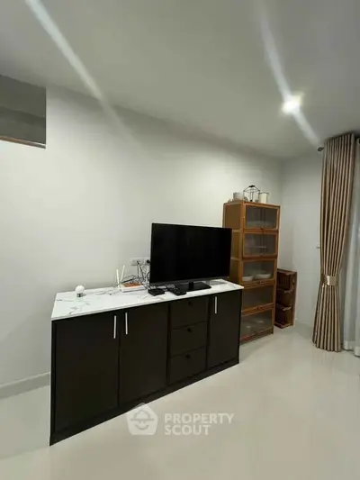 Modern living room with sleek TV stand and stylish shelving unit