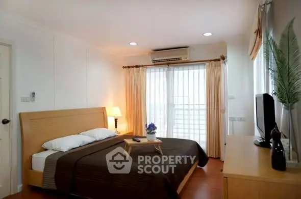 Spacious bedroom with modern decor and natural light