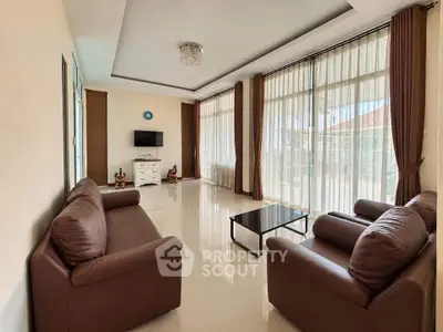 Spacious living room with modern furniture and large windows for natural light.