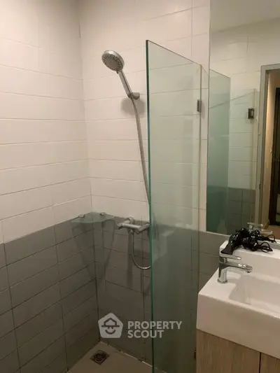 Modern bathroom with glass shower partition and sleek sink design