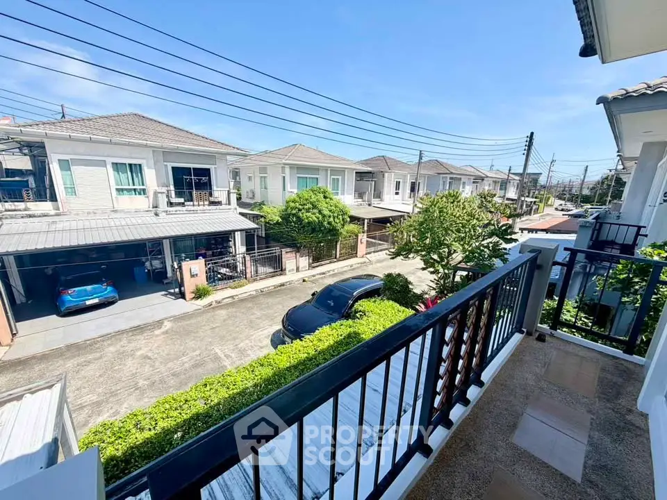 Charming residential street view from a cozy balcony in a suburban neighborhood.