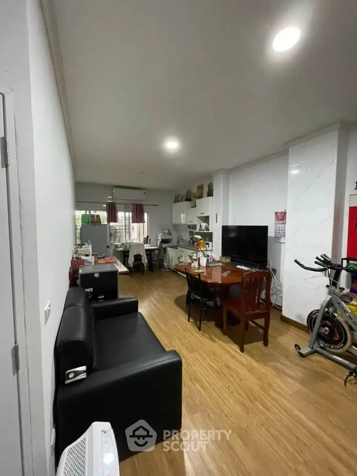 Spacious living room with modern decor and exercise equipment