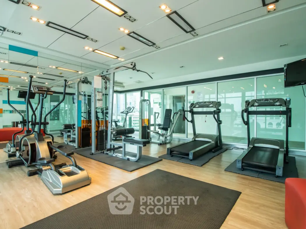 Modern gym with state-of-the-art fitness equipment in a luxury residential building.