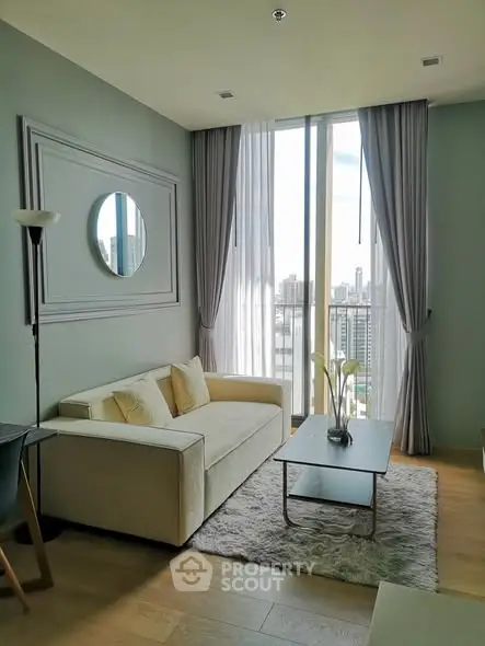 Modern living room with city view, featuring elegant decor and natural light.