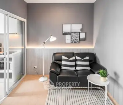 Modern living room with sleek black sofa and stylish decor