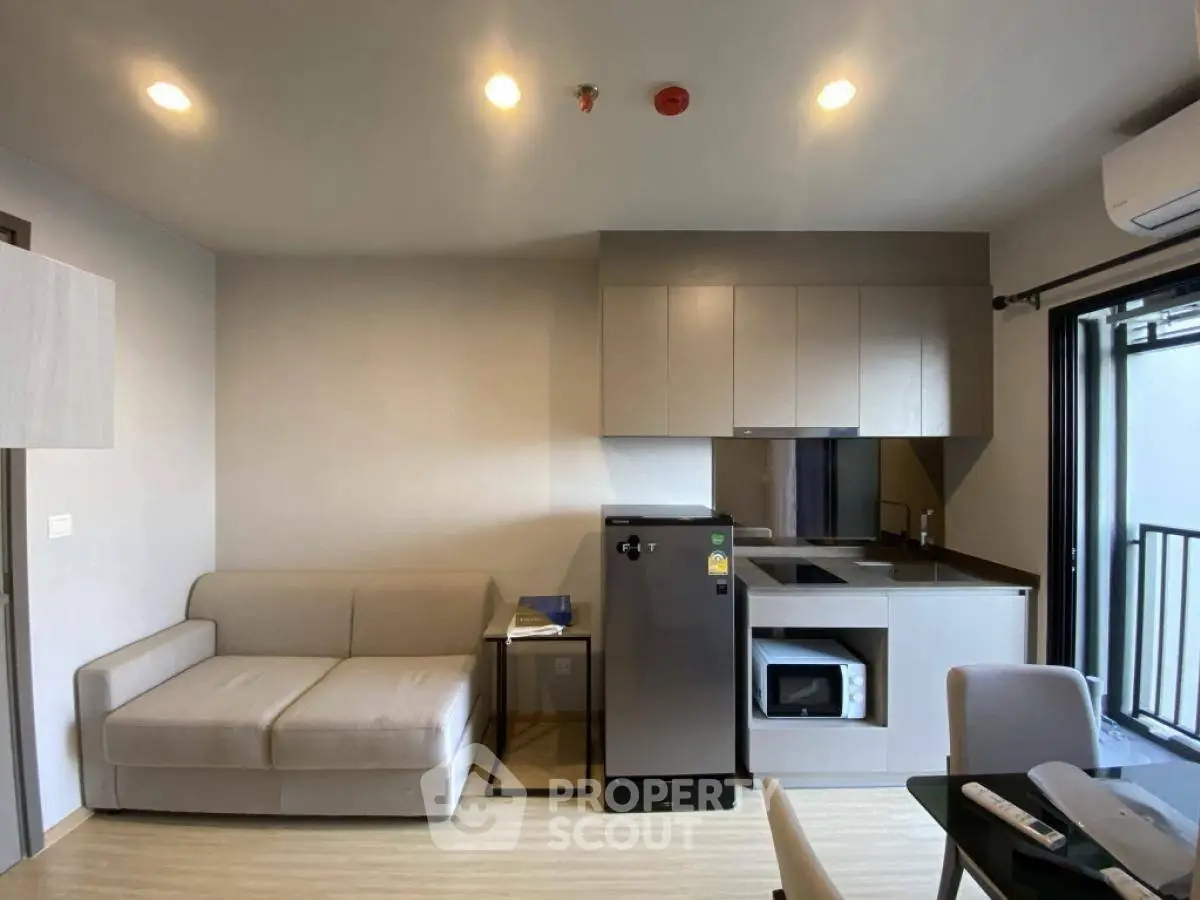 Modern apartment interior with compact kitchen and cozy living area