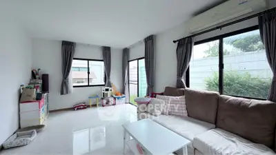 Spacious living room with large windows and modern furnishings in a bright, airy home.