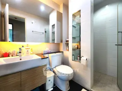 Modern bathroom with sleek fixtures and ample storage in a contemporary apartment.