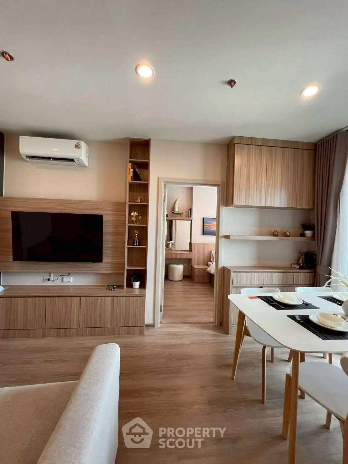 Modern living room with open layout and stylish wooden cabinetry