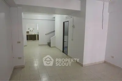 Spacious open layout interior with tiled flooring and neutral walls, ideal for customization.