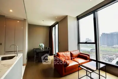 Modern living room with large windows and city view, featuring a cozy orange sofa and sleek dining area.
