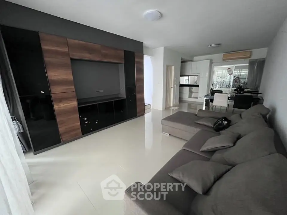 Spacious modern living room with sleek furniture and open layout, perfect for contemporary living.