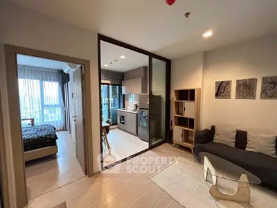 Modern open-plan apartment with cozy living room and sleek kitchen design.