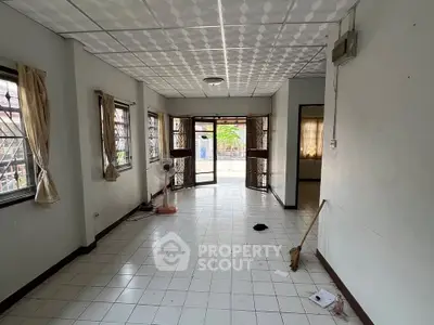 Spacious living room with tiled floor and large windows for natural light