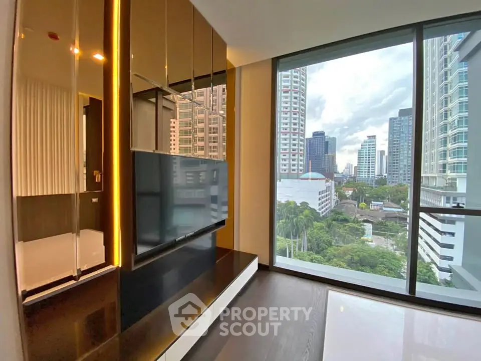Modern living room with floor-to-ceiling windows offering stunning city views.