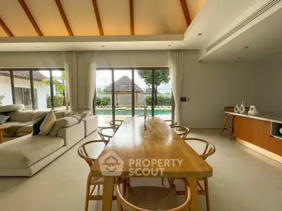 Luxurious open-plan living room with pool view and elegant dining area