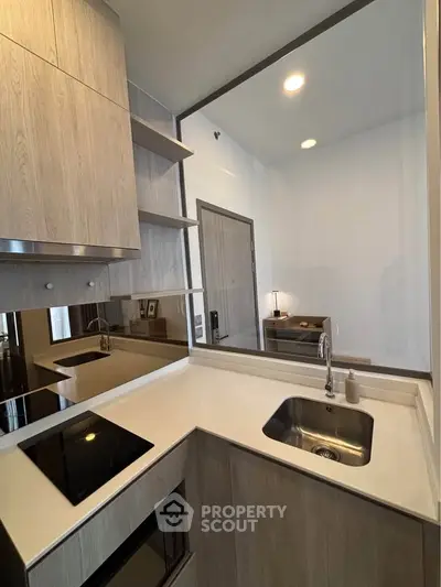 Modern kitchen with sleek cabinetry and built-in appliances in a compact layout.