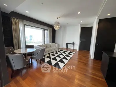 Elegant living room with hardwood floors, modern chandelier, and city view.