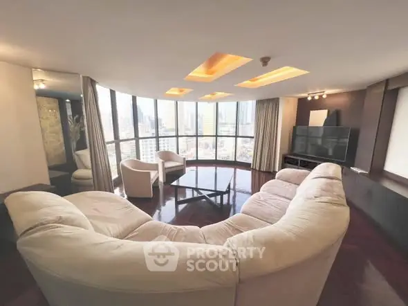 Luxurious curved living room with panoramic city views and plush seating
