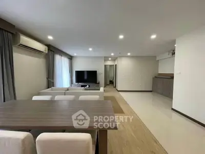 Spacious modern living room with elegant dining area and sleek interior design.