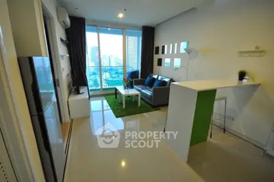 Modern living room with city view, sleek furniture, and open layout in high-rise apartment.